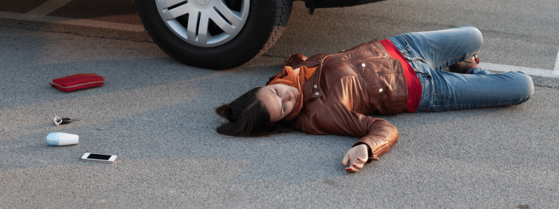 Emergency medical technician helping accident victim at scene 