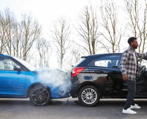 Two cars involved in a rear-end collision on the road — visual representing common mistakes after a car accident and how to avoid them