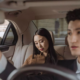 Passengers riding in the backseat of a car, representing when to consult a rideshare injury lawyer after an accident.