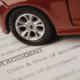 Car accident attorneys in Bend, Oregon prepare legal documents with a red toy car resting on top as a paper weight.