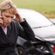 Injured driver calling for help after a car accident involving damaged vehicles