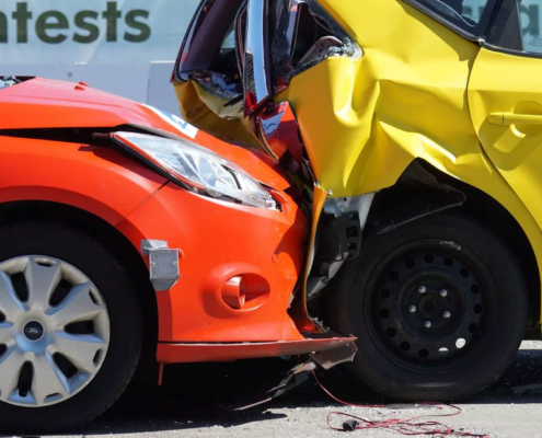 Rear-end collision between two vehicles showing significant crash damage.