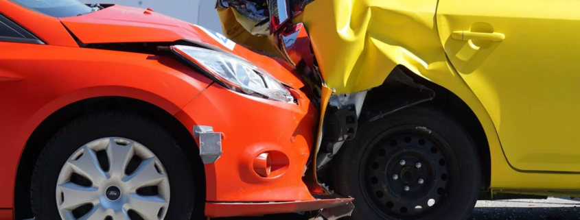 Rear-end collision between two vehicles showing significant crash damage.