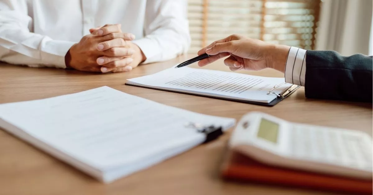 Personal injury attorney reviewing claim documents with client after a rear-end accident.