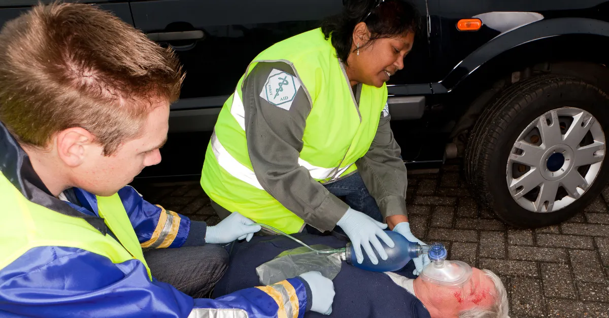 Emergency responders provide medical assistance to an injured driver after a Portland car accident.